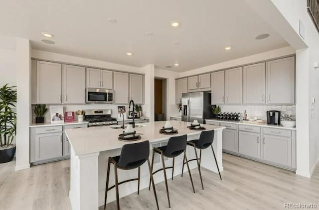16947 W 92nd Dr, Arvada, CO 80007 - kitchen with appliances with stainless steel finishes, gray cabinets, a sink, backsplash, and recessed lighting