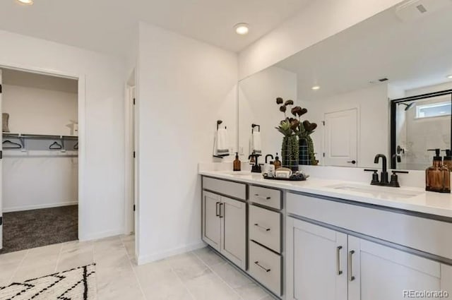 16947 W 92nd Dr, Arvada, CO 80007 - full bath with double vanity, a walk in closet, baseboards, recessed lighting, and a shower with shower door