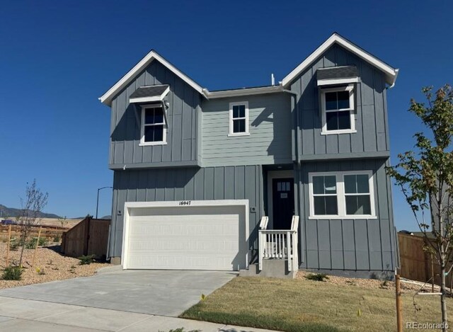 16947 W 92nd Dr, Arvada, CO 80007 - view of front of property featuring an attached garage, driveway, and board and batten siding