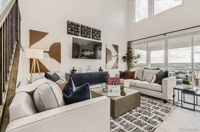 16947 W 92nd Dr, Arvada, CO 80007 - living area featuring a towering ceiling and wood finished floors