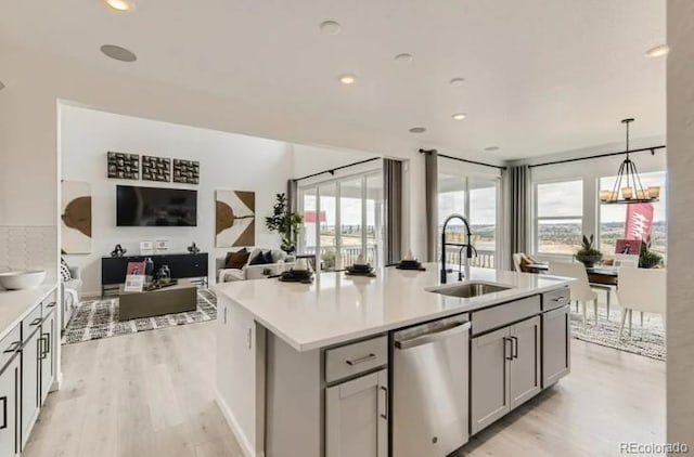 16947 W 92nd Dr, Arvada, CO 80007 - kitchen featuring dishwasher, a sink, light wood finished floors, gray cabinets, and light countertops