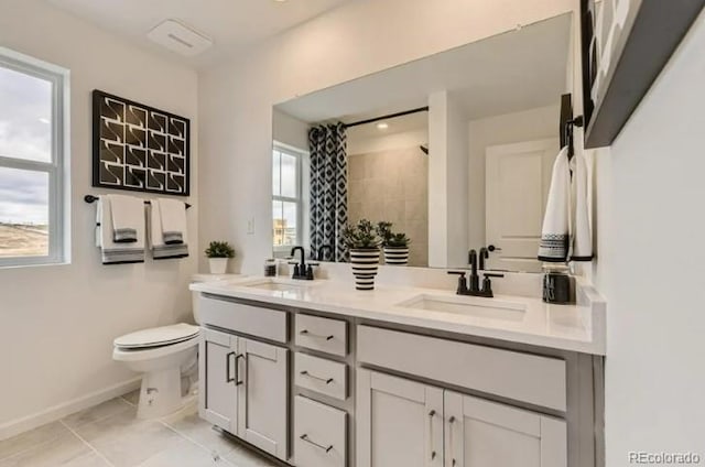 16947 W 92nd Dr, Arvada, CO 80007 - bathroom with double vanity, toilet, baseboards, a shower, and tile patterned flooring