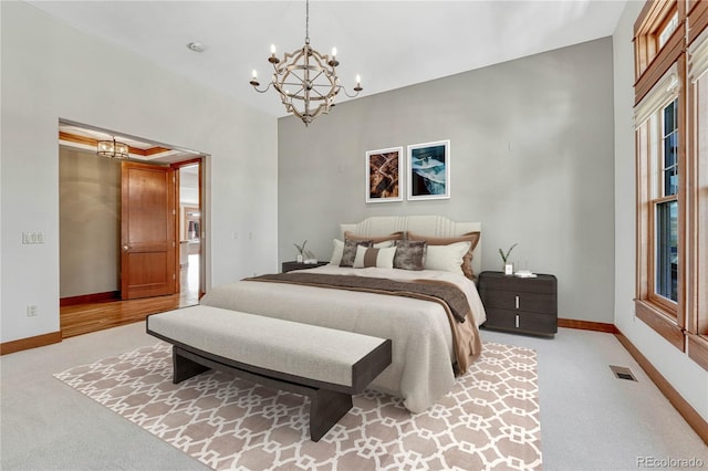 carpeted bedroom featuring a chandelier