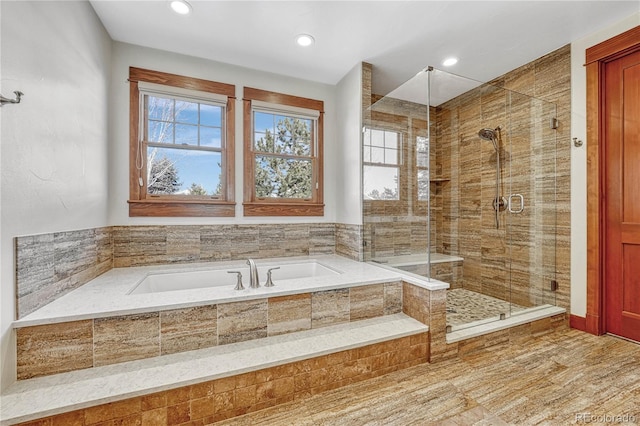 bathroom featuring separate shower and tub