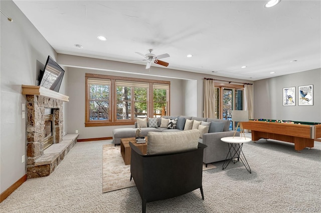 living room featuring carpet floors, a stone fireplace, ceiling fan, and billiards