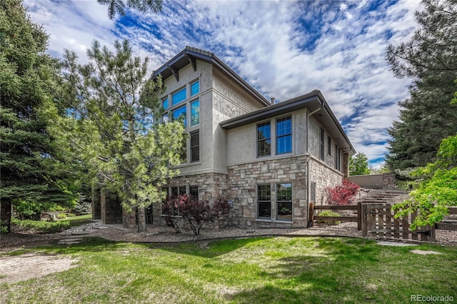 rear view of property featuring a yard