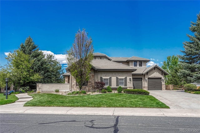 view of front of home featuring a front lawn and a garage