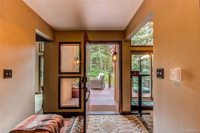 25257 Snyder Ave, Conifer, CO 80433 - doorway to outside featuring a textured wall and baseboards
