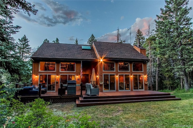 25257 Snyder Ave, Conifer, CO 80433 - rear view of property with a chimney, a lawn, a shingled roof, and a deck
