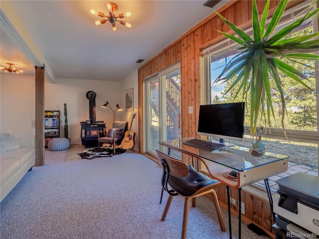 30455 Mountainside Dr, Buena Vista, CO 81211 - carpeted office space with a wood stove, plenty of natural light, wooden walls, and a chandelier