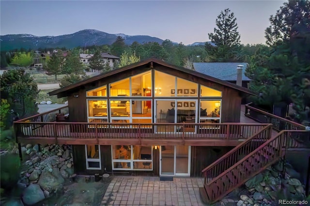30455 Mountainside Dr, Buena Vista, CO 81211 - back of property with a deck with mountain view, stairs, and a patio area