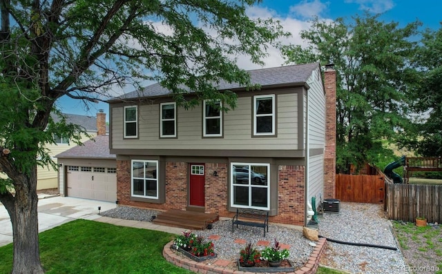 312 Allen St, Golden, CO 80401 - colonial home with a chimney, brick siding, driveway, and an attached garage
