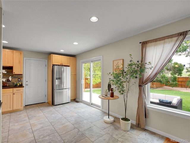 312 Allen St, Golden, CO 80401 - kitchen with stainless steel fridge with ice dispenser, light brown cabinetry, tasteful backsplash, recessed lighting, and dark countertops