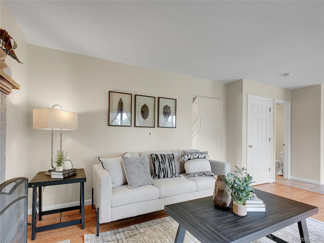 312 Allen St, Golden, CO 80401 - living area featuring light wood-type flooring and a brick fireplace