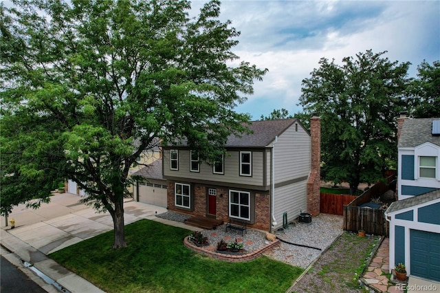 312 Allen St, Golden, CO 80401 - view of front of house with driveway, a garage, brick siding, and a chimney