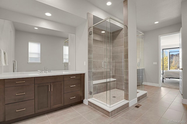 bathroom featuring tile patterned flooring, vanity, and an enclosed shower