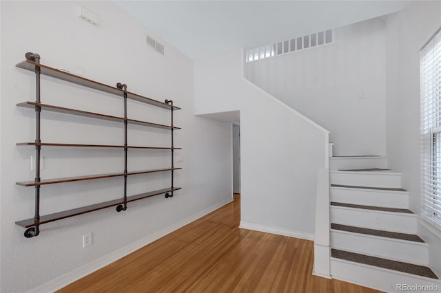 stairway featuring hardwood / wood-style floors