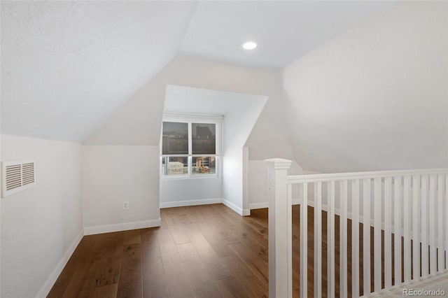 bonus room with hardwood / wood-style floors and lofted ceiling