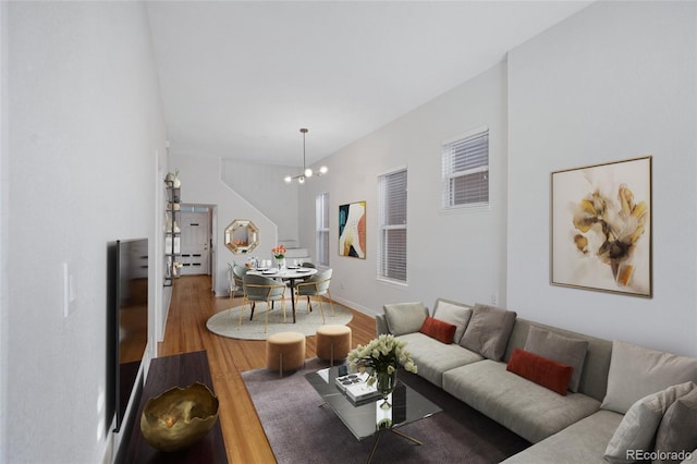 living room featuring wood finished floors and a chandelier