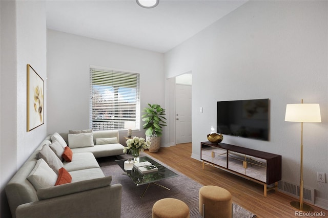 living area featuring wood finished floors and baseboards