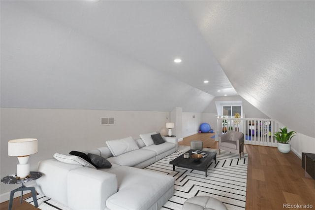 living room with baseboards, vaulted ceiling, wood finished floors, and recessed lighting