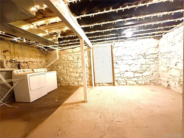 unfinished below grade area with washing machine and dryer