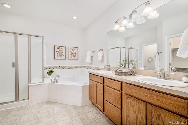 bathroom with shower with separate bathtub and vanity