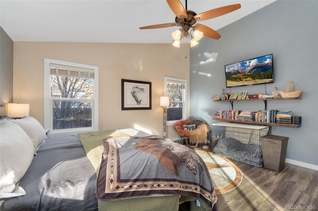 bedroom with hardwood / wood-style flooring, ceiling fan, and lofted ceiling