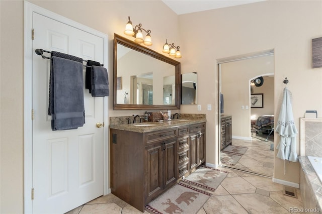 bathroom featuring vanity and a bath