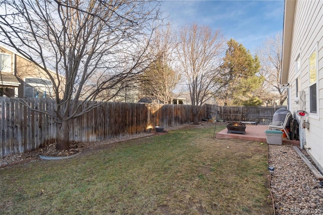 view of yard with a fire pit and a patio area