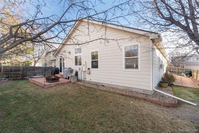 rear view of property featuring a yard