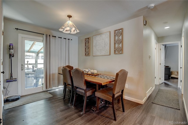 dining room featuring wood finished floors, visible vents, and baseboards