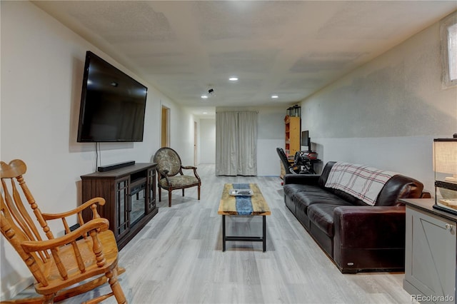 living area featuring light wood-style flooring and recessed lighting