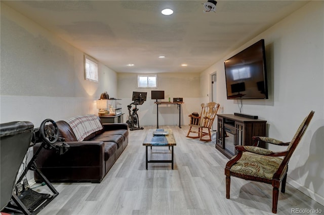 living room with light wood-type flooring and recessed lighting