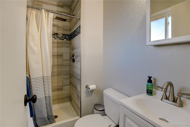 full bathroom with toilet, a shower stall, and vanity