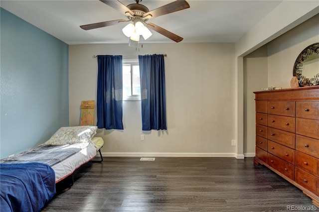 bedroom featuring a ceiling fan, baseboards, and wood finished floors