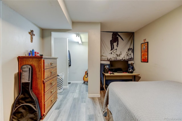 bedroom featuring baseboards and light wood-style floors