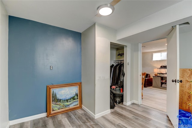 hall featuring wood finished floors and baseboards