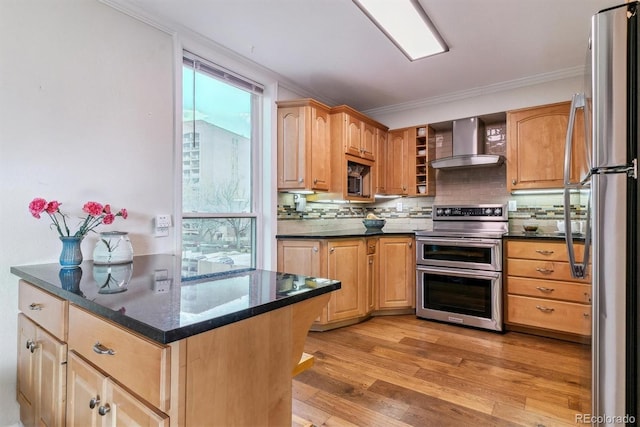 kitchen with crown molding, stainless steel appliances, tasteful backsplash, light wood-style flooring, and wall chimney exhaust hood