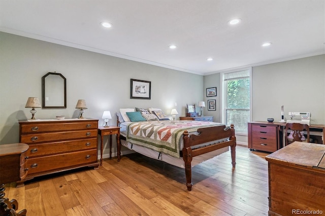 bedroom with recessed lighting, crown molding, and light wood-style flooring