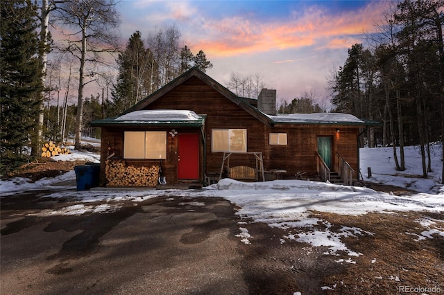 rustic home featuring a chimney