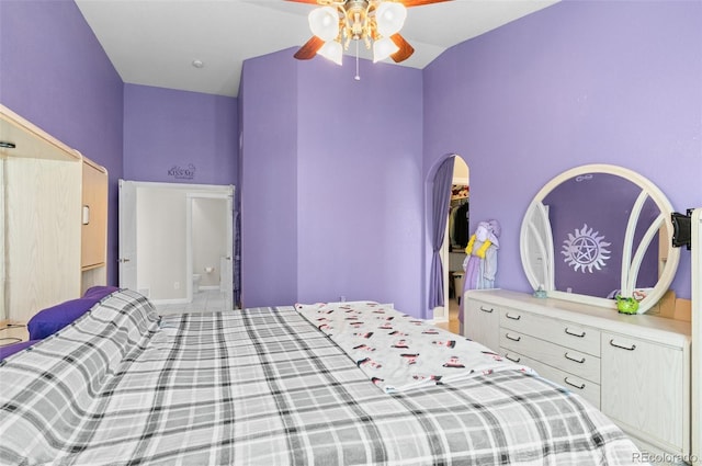 bedroom with vaulted ceiling, ceiling fan, and a closet