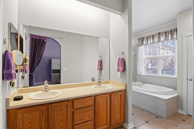 full bath with a garden tub, double vanity, tile patterned flooring, and a sink