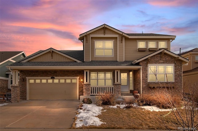 craftsman-style home featuring an attached garage, stone siding, concrete driveway, and roof with shingles