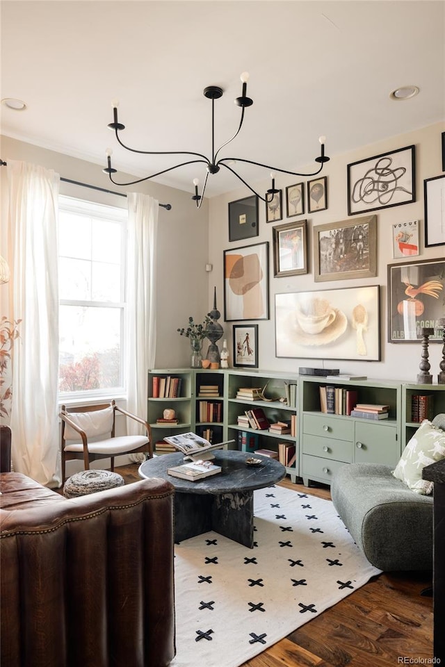 living area featuring a chandelier and hardwood / wood-style flooring