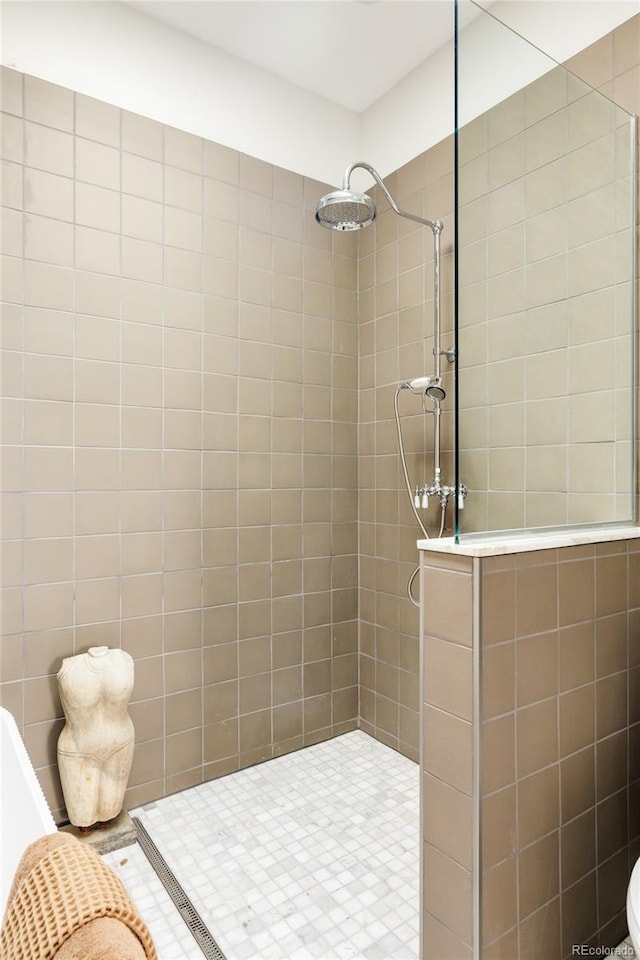 bathroom with a tile shower