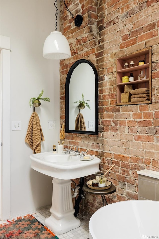 bathroom with brick wall