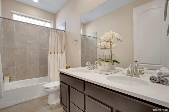 full bathroom with double vanity, toilet, shower / bath combo with shower curtain, and a sink