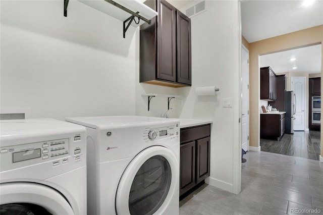 laundry area featuring visible vents, washer and dryer, a sink, cabinet space, and baseboards