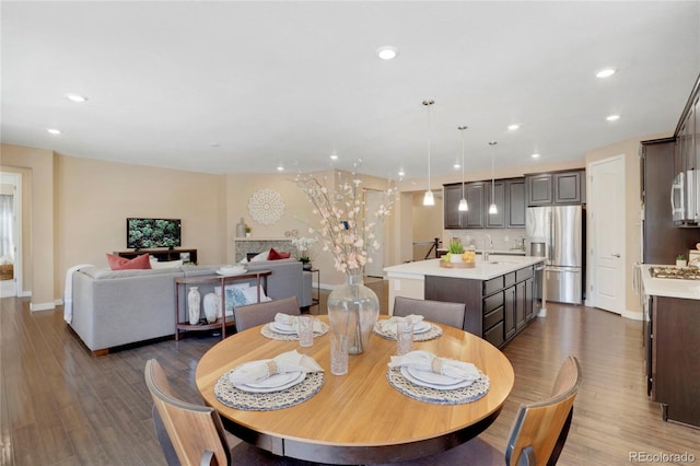 dining room with wood finished floors, baseboards, and recessed lighting
